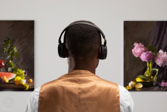 An African paint artist listening to music while engaging with his paintings